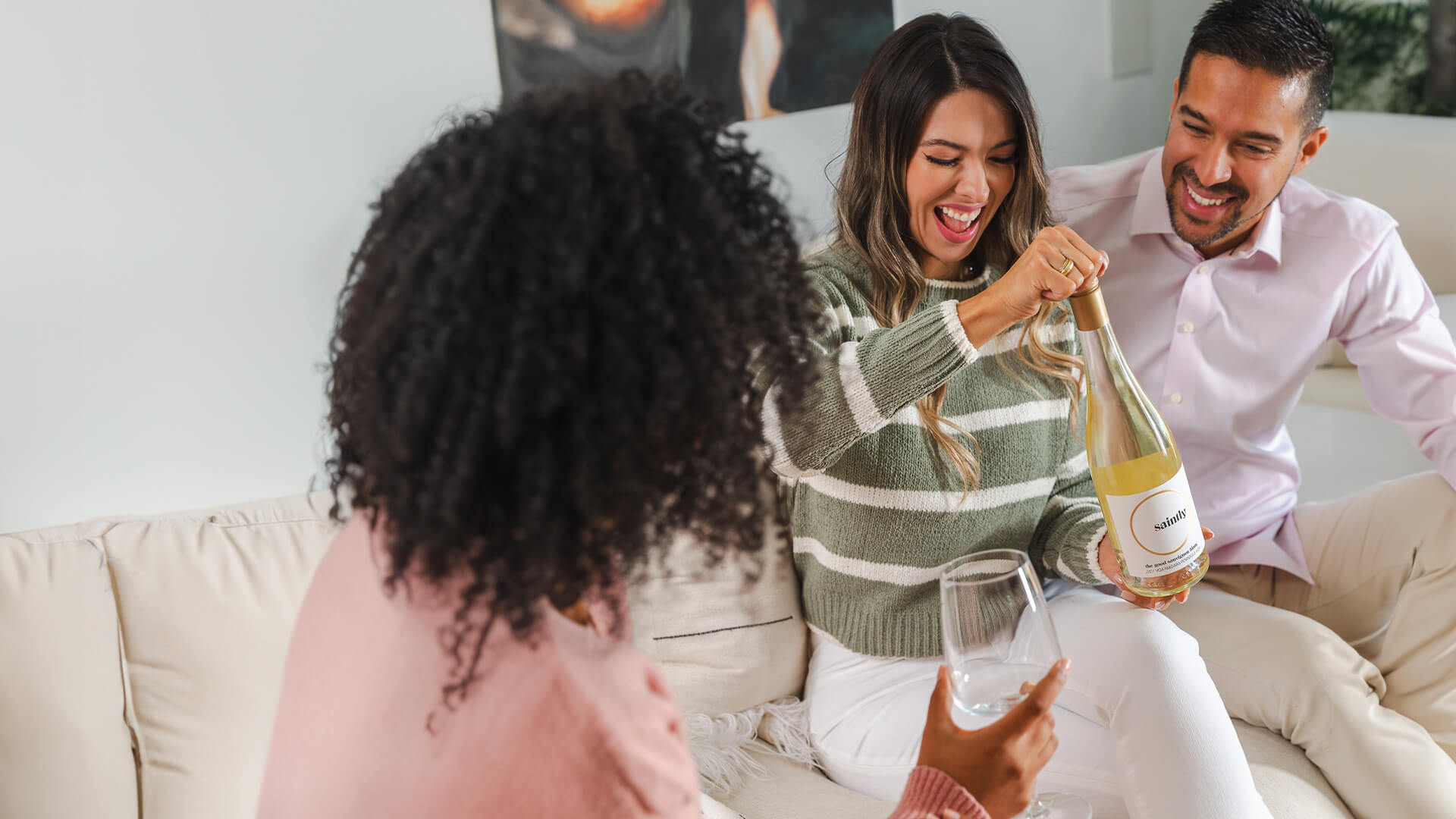 Friends enjoying a bottle of Saintly Sauvignon Blanc.